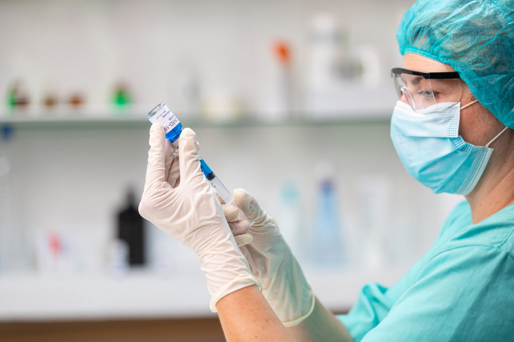Female doctor preparing vaccine