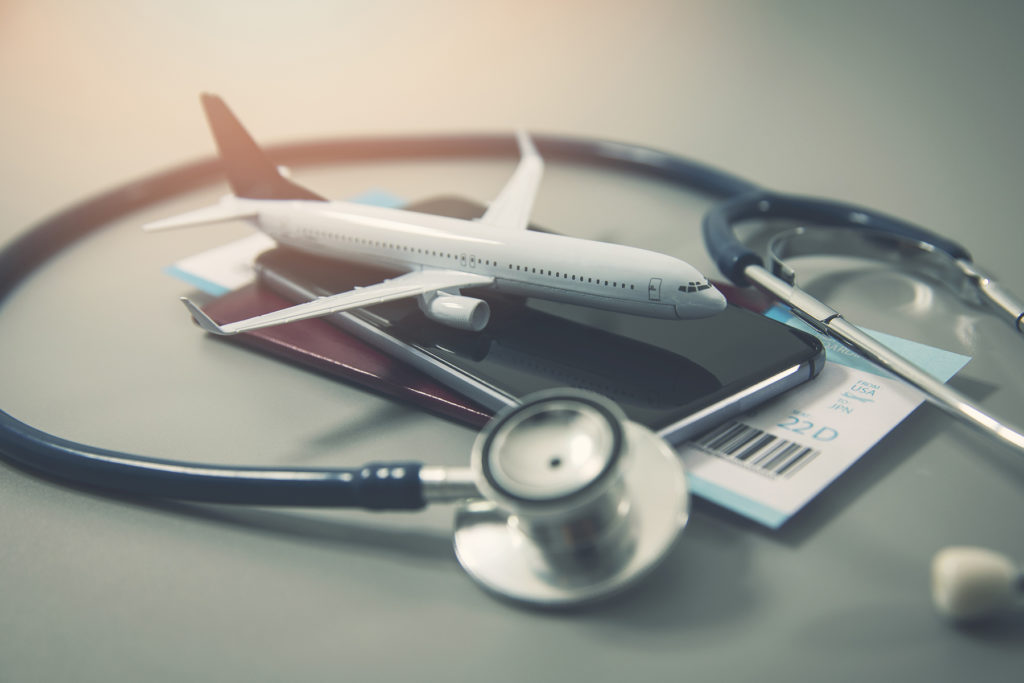 stethoscope and toy airplane on wallet