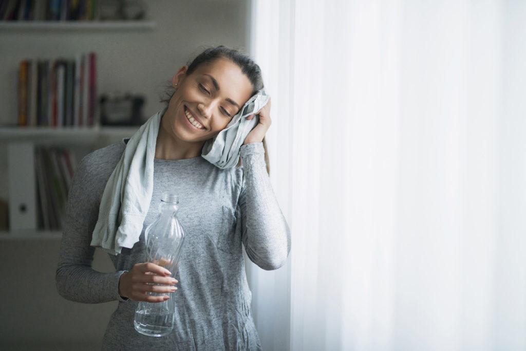 Woman wipes sweat away after workout