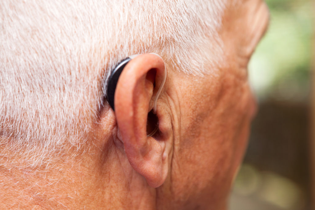 Senior Man's Ear with Hearing Aid