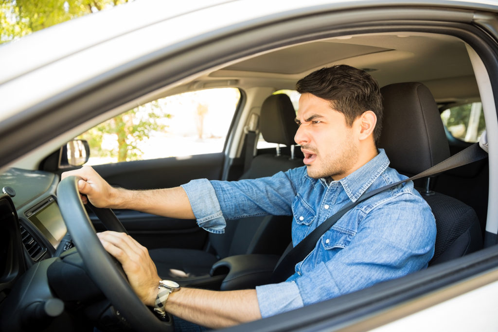 Angry man driving a vehicle