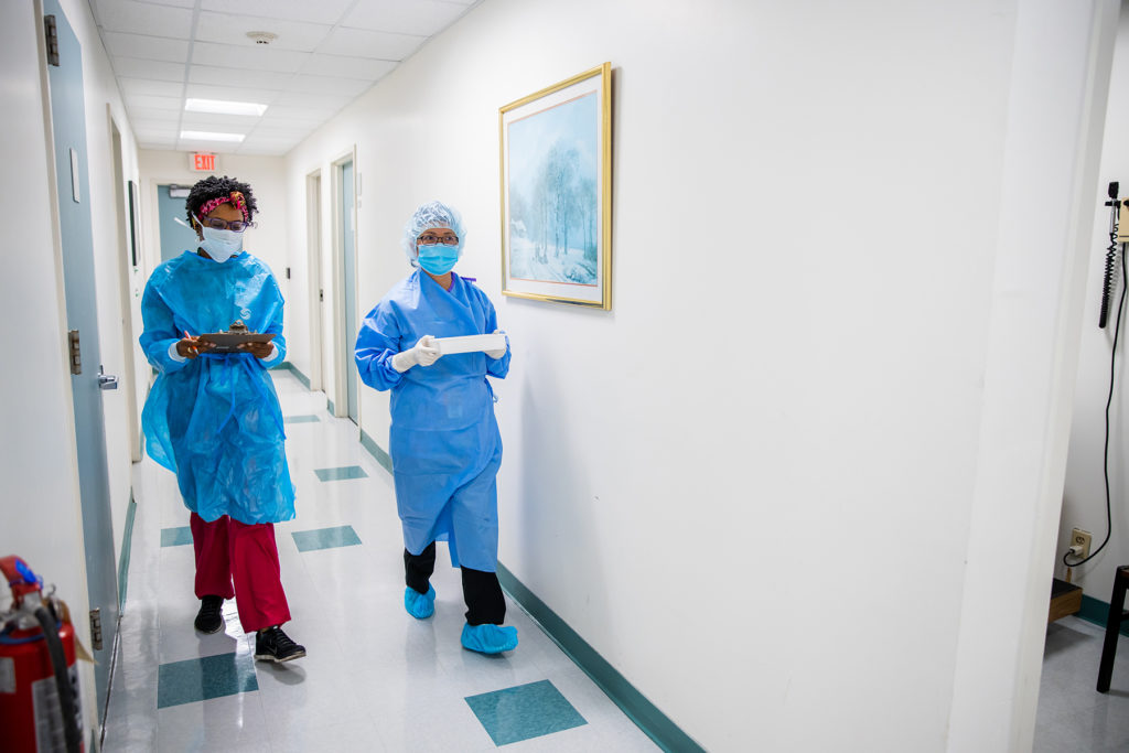 Two researchers walk hallway