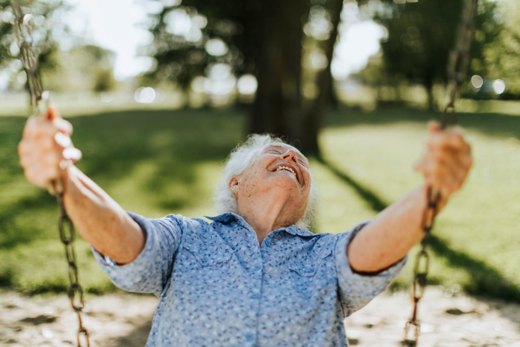Senior man smiles on swing
