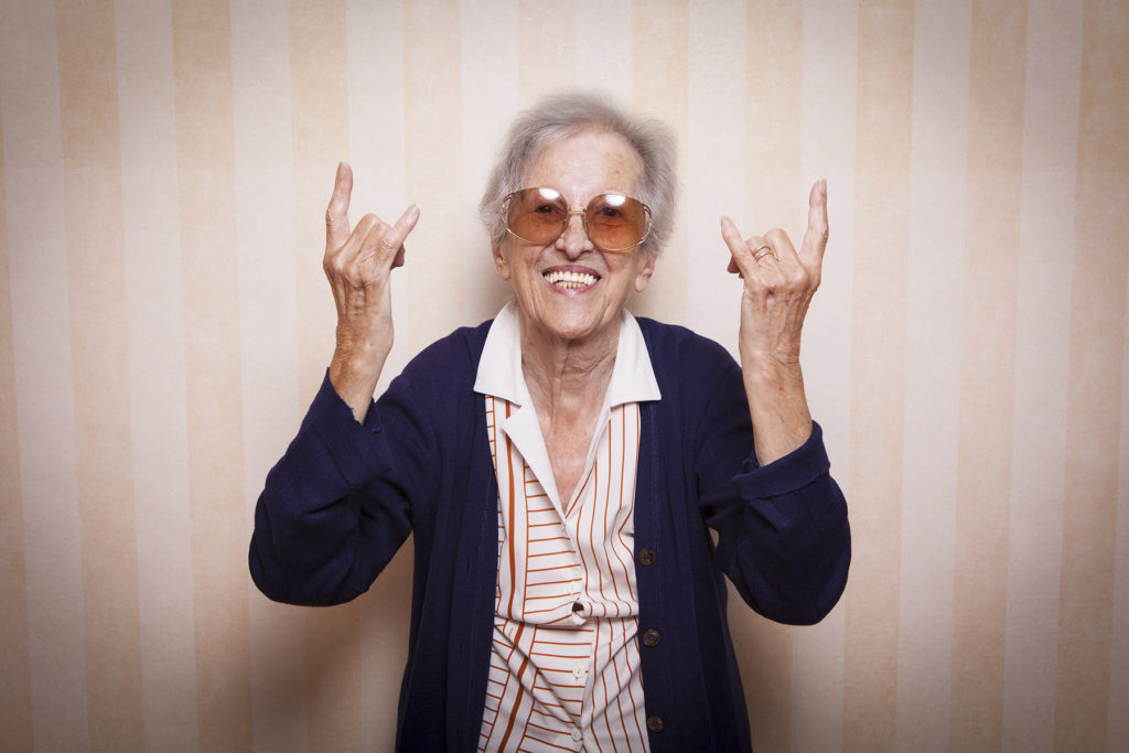 elder lady making rock on sign