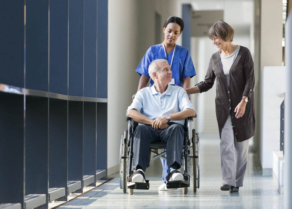 Male patient being wheeled down hallway