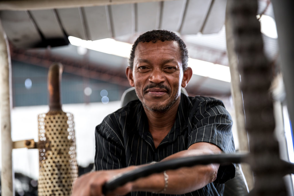 Man on forklift looks at camera