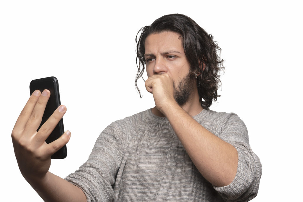 Man looks aghast at his phone