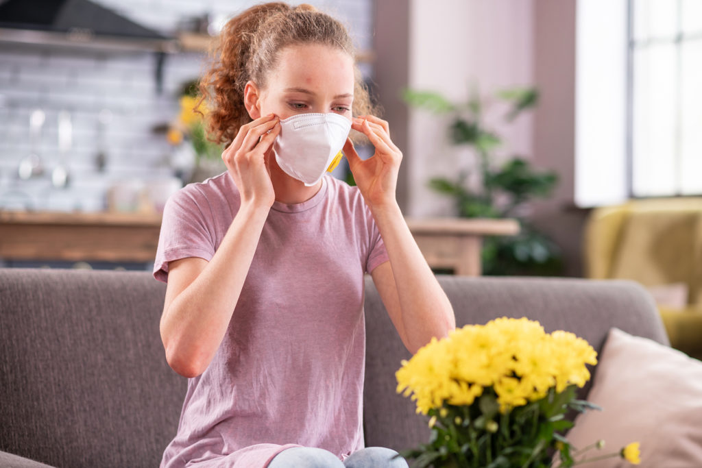 woman with skin issue wearing COVID mask