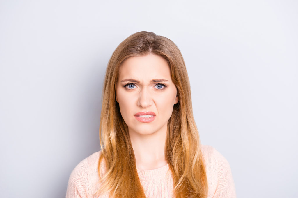 Close up of woman looking uncomfortable