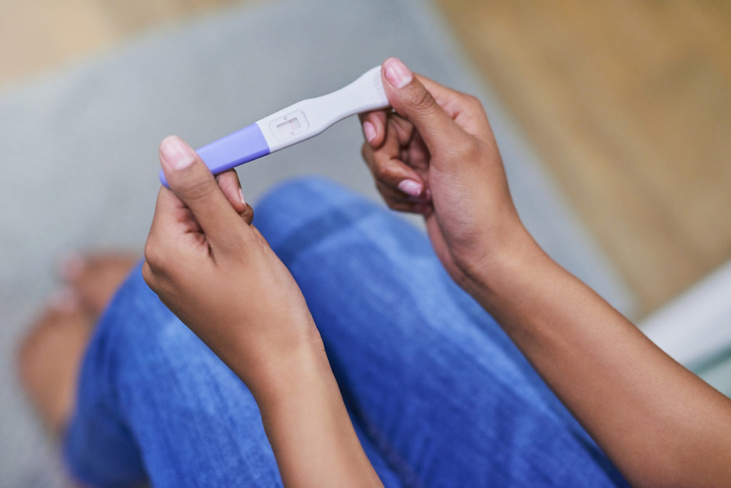 woman holding a pregnancy test