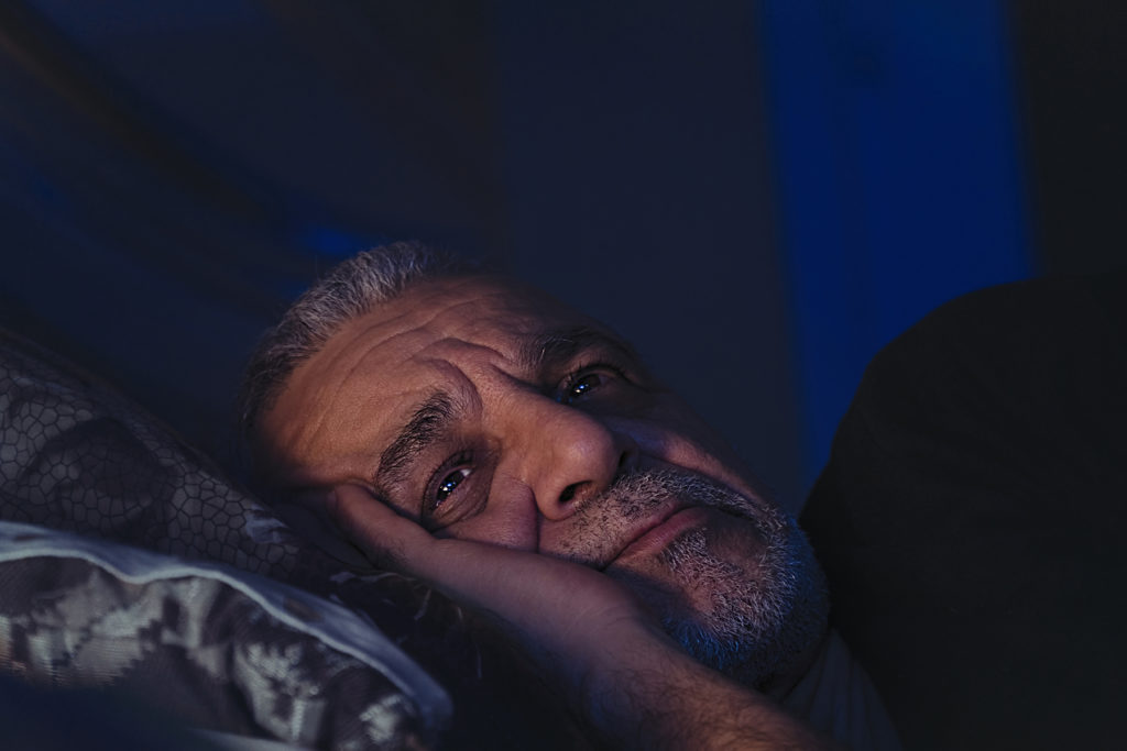 elderly man annoyed to be awake