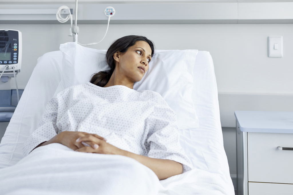 Female patient thoughtful in bed