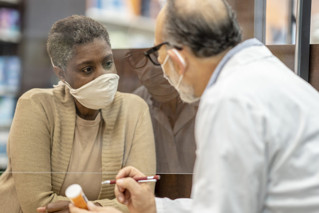 woman talking to pharmacist or doctor