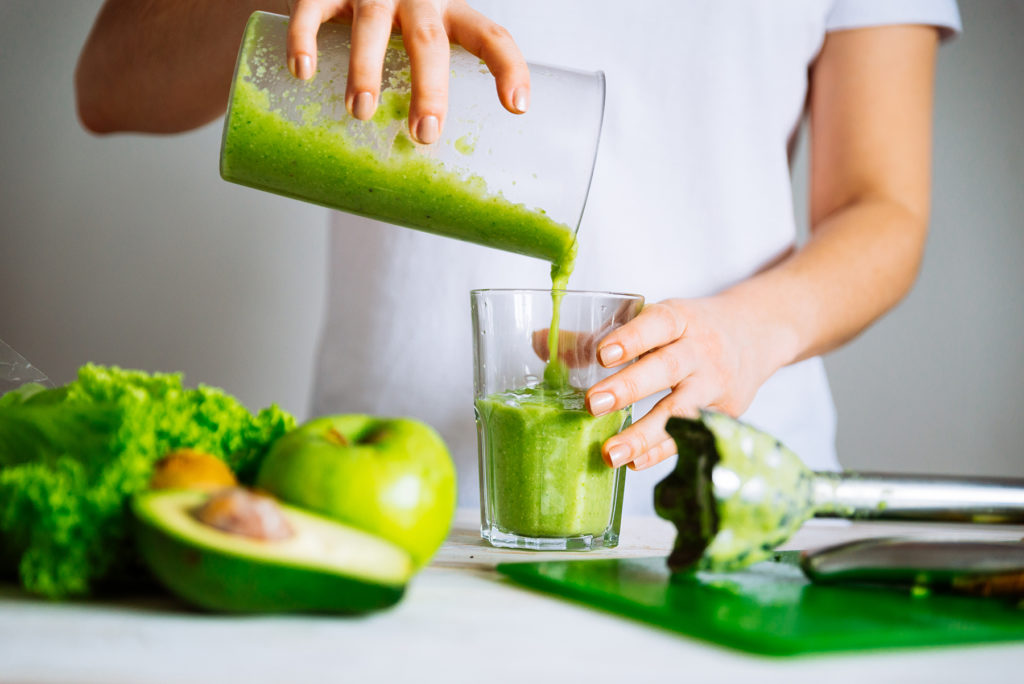 Woman pours a smoothie