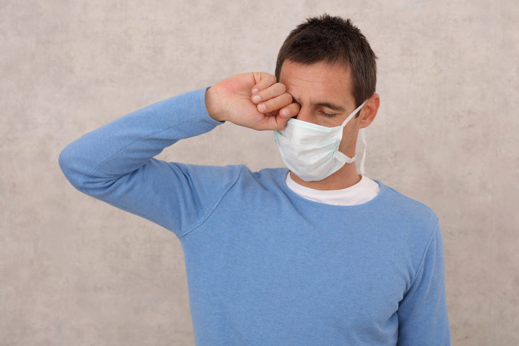 man wearing mask with irritated eyes