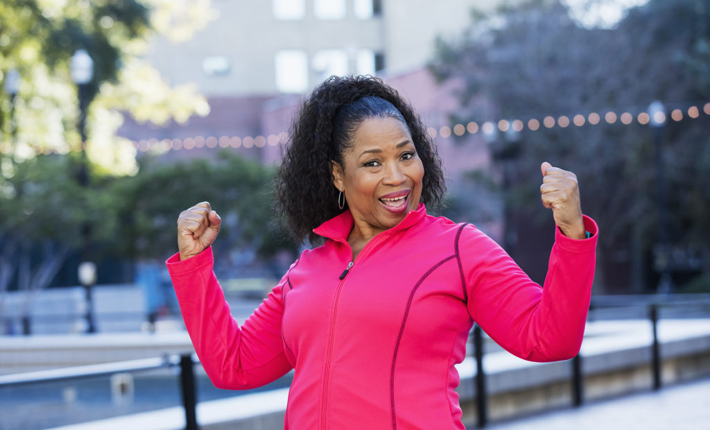 African American woman in exercise jacket smiling