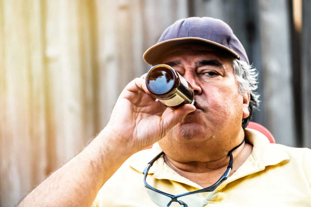 Hispanic Mature senior man having a beer