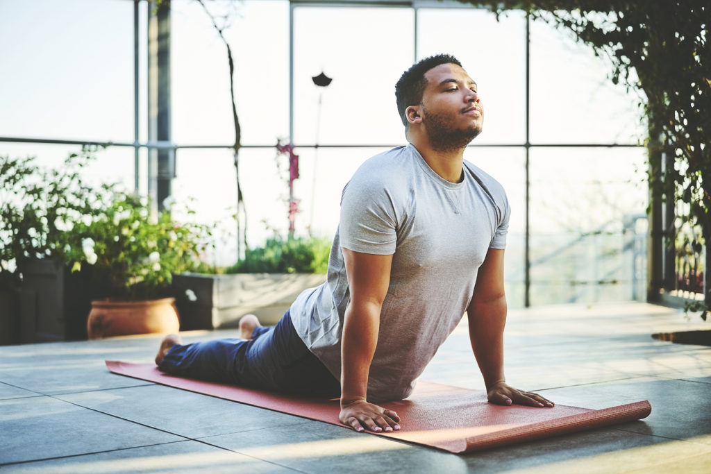 man doing yoga for self care