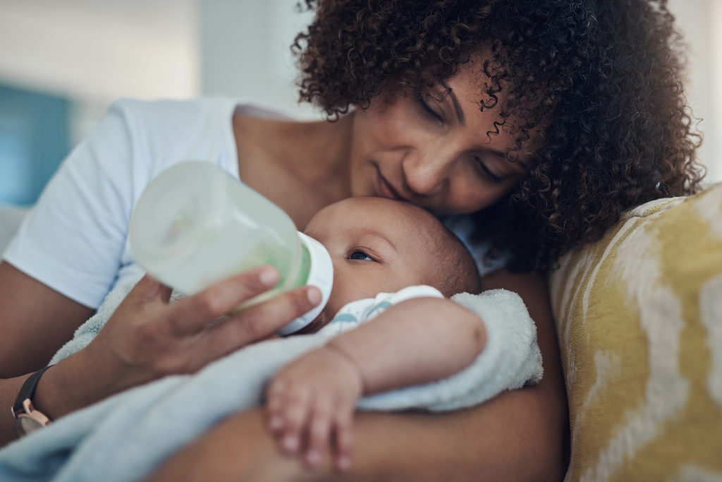 Mother feeding baby formula