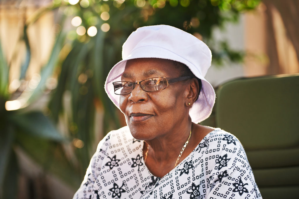 Senior African American woman sitting alone outside