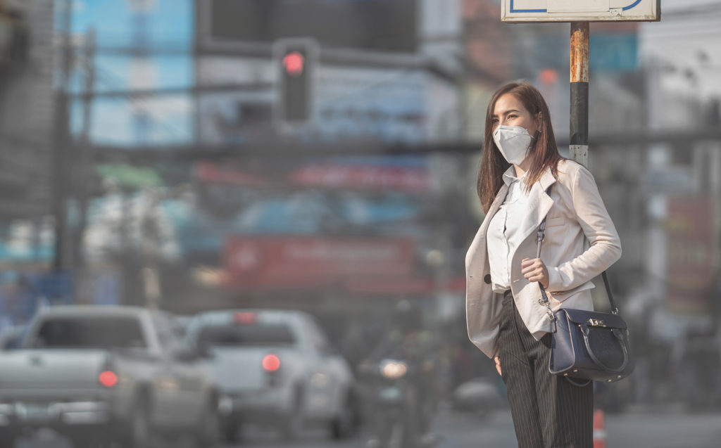 woman walks outside. Air pollution concept.