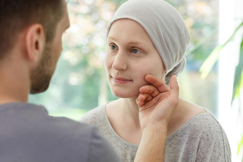 Husband touching cancer patient wife's cheek