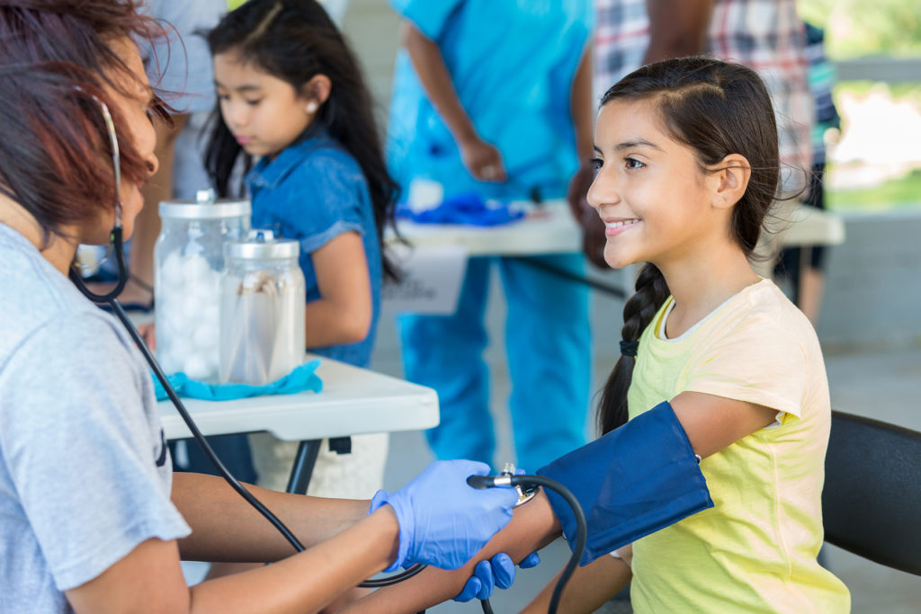girl getting blood pressure checked