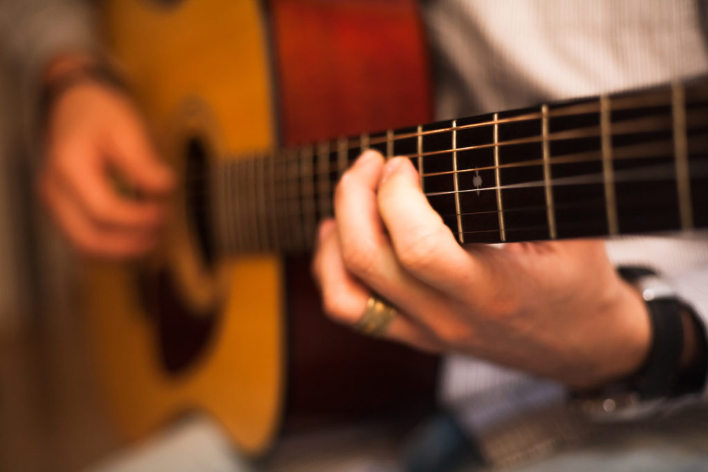 hands playing guitar
