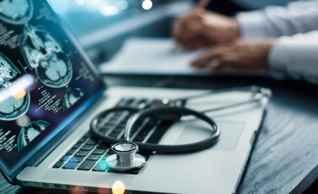screen interface on laptop and stethoscope