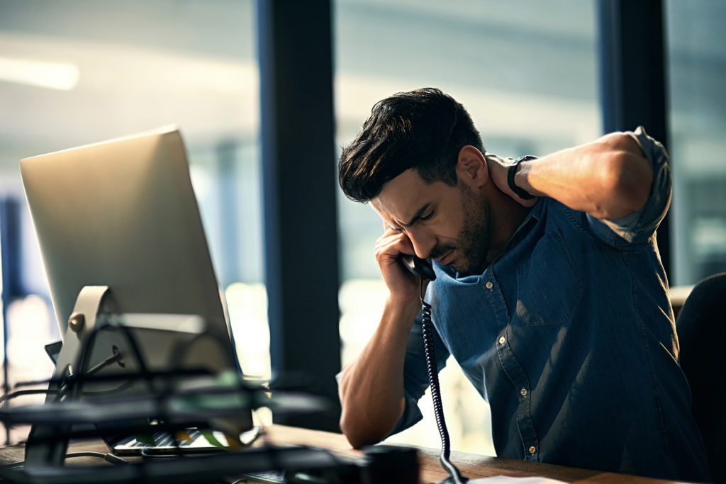 Stressed man at desk at work