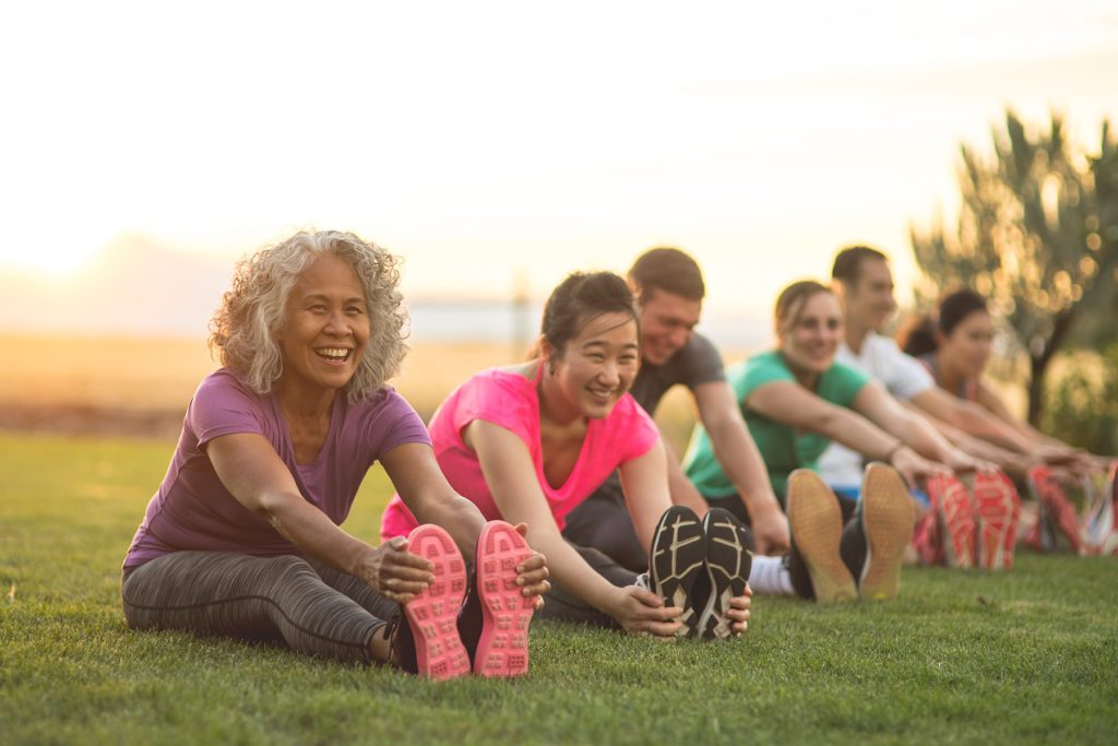 diverse group stretching on grass